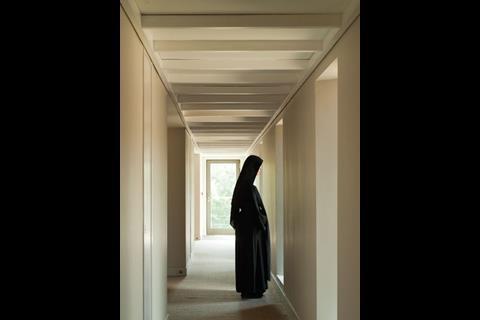 A nun in the corridor linking the “cells”
